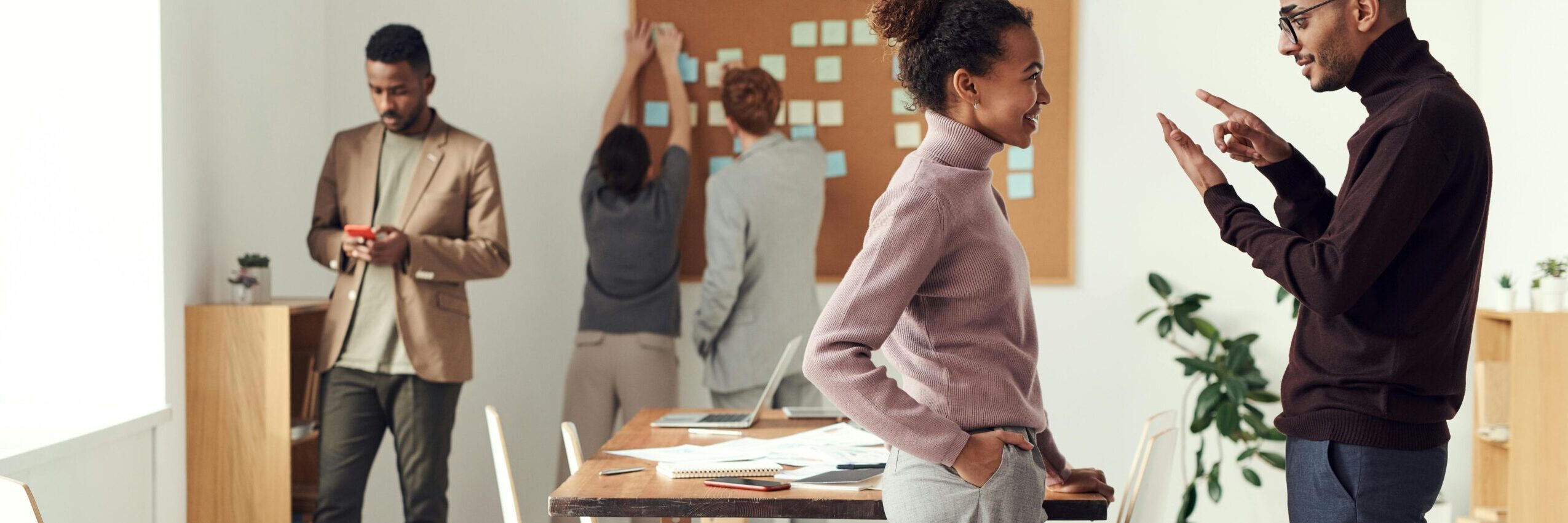 Colleagues engaging in teamwork and brainstorming in a modern office space.